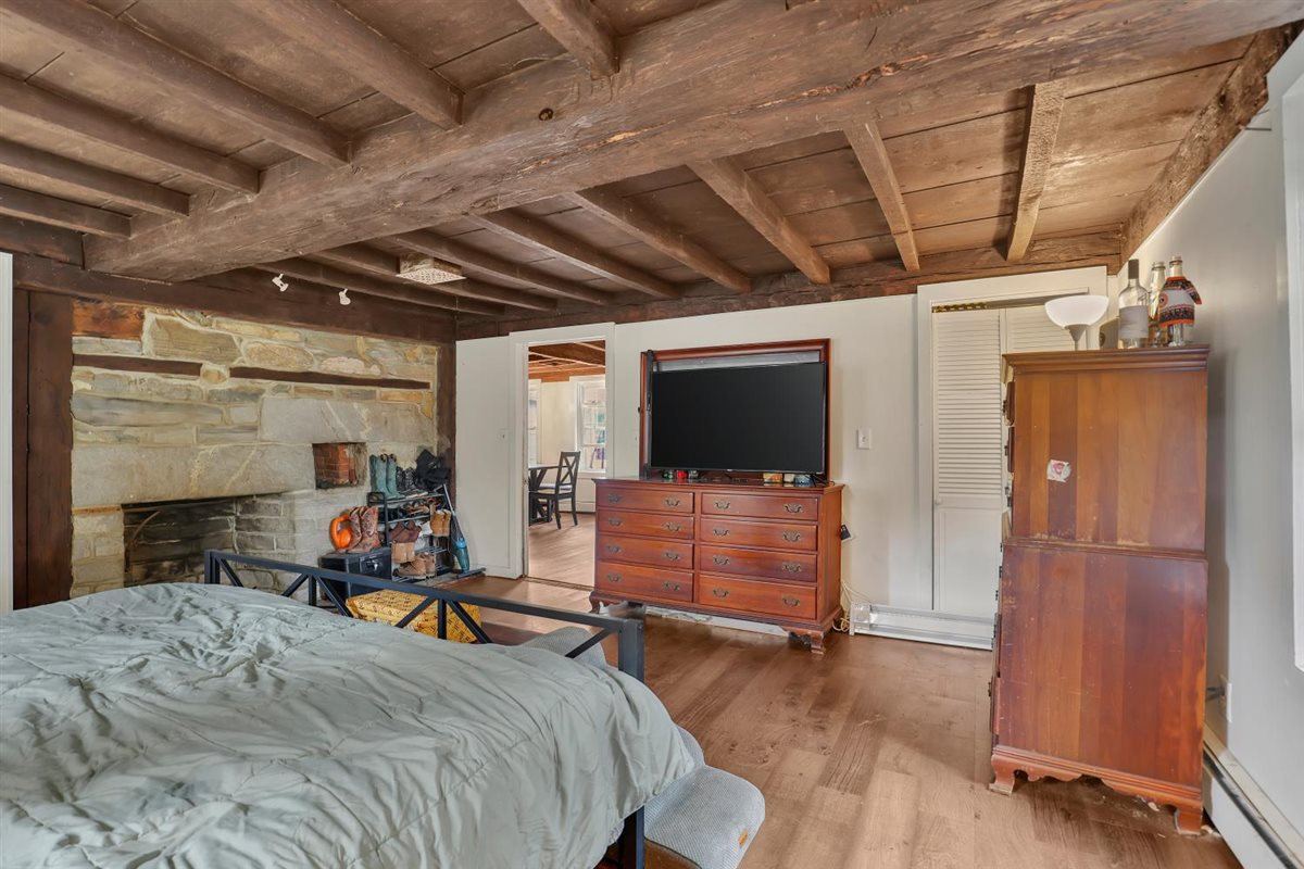 Primary bedroom with stone fireplace